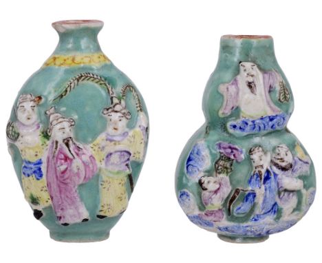 TWO CHINESE FAMILLE ROSE PORCELAIN SNUFF BOTTLES, 20TH CENTURYdouble gourd ovoid, each moulded in high relief with figures ag