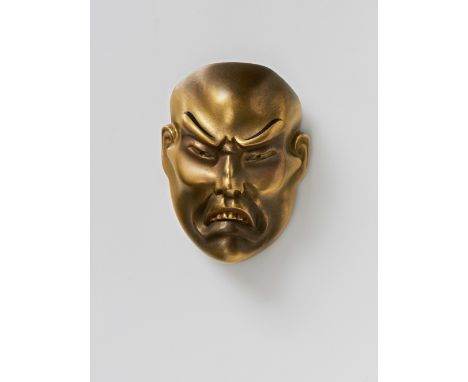 A JAPANESE MASK NETSUKE OF A MOROSE MAN, 20TH CENTURYgold lacquered wood, unsigned5cm high Peter E. Müller Japanese Mask Coll