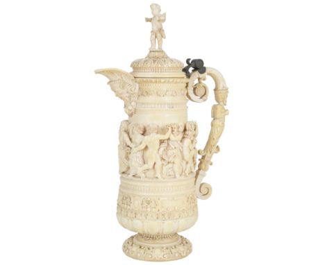 ~AN IVORY TANKARD, GERMAN, CIRCA 1880carved with a bacchic procession above foliate strapwork and lobes, the short pedestal f