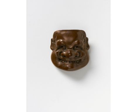 A JAPANESE MASK NETSUKE OF BUAKU, BY HOZAN, EARLY 20TH CENTURYdark stained boxwood, signed ‘Hozan saku’3.6cm high Peter E. Mü