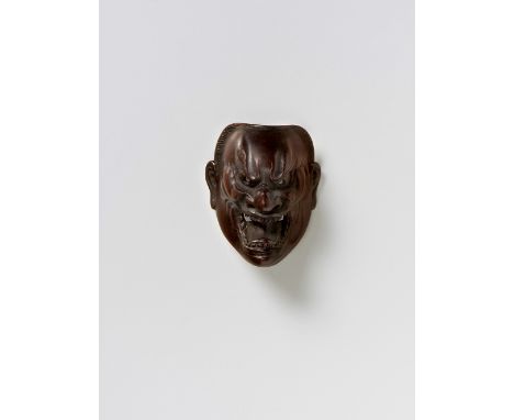 A JAPANESE MASK NETSUKE OF SHIKAMI, DEME FAMILY, 19TH CENTURYdark stained boxwood, signed ‘Deme saku’3.3cm high Peter E. Müll