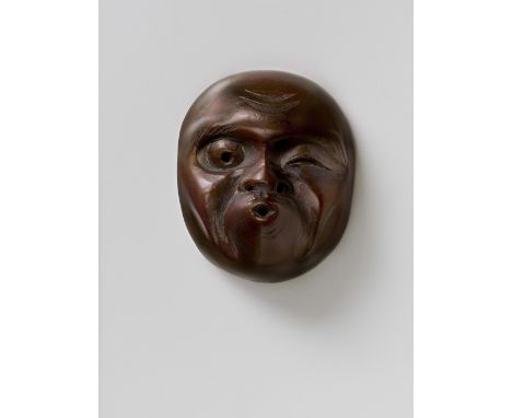 A JAPANESE MASK NETSUKE OF USOBUKI, BY SUKENOBU, EARLY 20TH CENTURYwood, signed ‘Sukenobu’4.9cm high Peter E. Müller Japanese