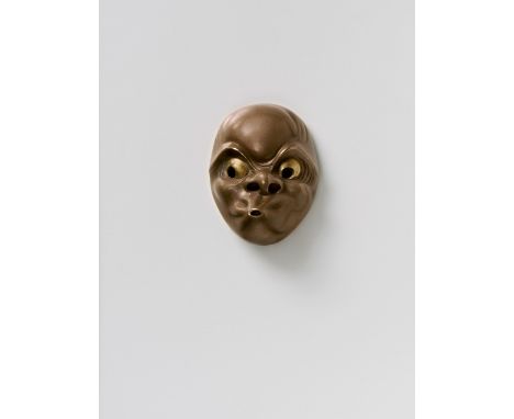A JAPANESE MASK NETSUKE OF USOBUKI, BY NAOYA, 20TH CENTURYcopper with gilt eyes and solid gold bar behind, signed ‘Naoya’ wit