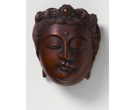 A JAPANESE MASK NETSUKE OF KANNON, BY NAITO KOSEKI, 1913dark stained boxwood, unsigned, with a label inscribed by the commiss