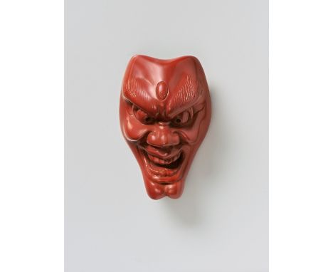 A JAPANESE MASK NETSUKE OF SHISHIGUCHI, BY KOMIN, 19TH CENTURYtsuishu lacquer, signed ‘Komin’5cm highThe signature might equa