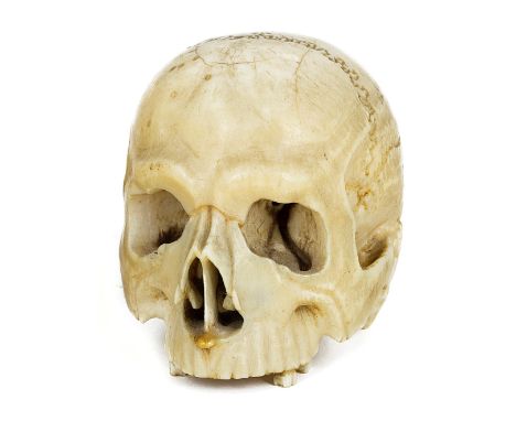 ~AN IVORY ‘VANITAS’ MODEL OF A HUMAN SKULL, PROBABLY GERMAN 18TH CENTURYwith finely detailed carving5cm long