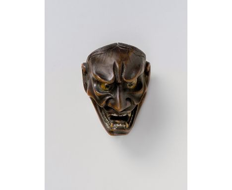 A JAPANESE MASK NETSUKE OF SHIKAMI, 19TH CENTURYstained boxwood with gold lacquer teeth and eyes, unsigned4.6cm high Peter E.