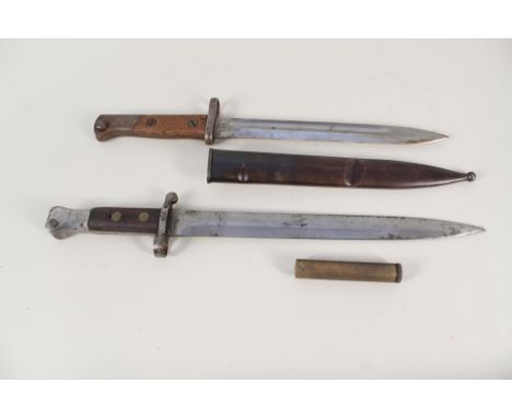 A model 1888 bayonet by Wilkinson (dated 4/99) with a Mauser bayonet and scabbard and an Enfield oil bottle