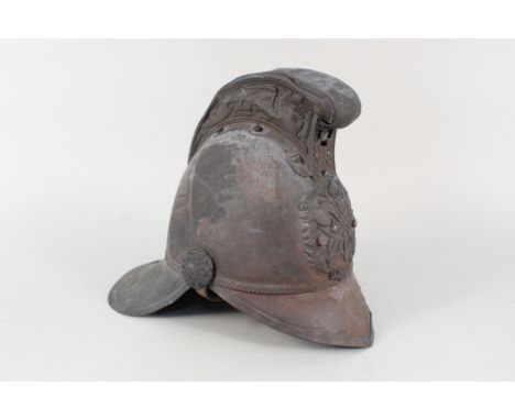 A vintage (early 20th Century) Merryweather style fireman's helmet, liner and leather chin strap in place, overall in worn co