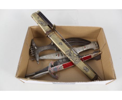 Six various knives/daggers including an unusual white metal hilted Janbiyya and a vintage stiletto, both without scabbards