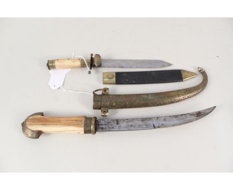 A vintage 'Jambya' with bone grip and white metal embellishment with a small Bowie, again with bone grip