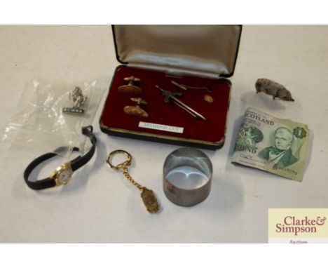 A silver napkin ring; a pair of cufflinks; lady's wrist watch; Scottish £1 note etc