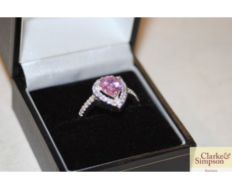 A heart shaped pink stone set dress ring