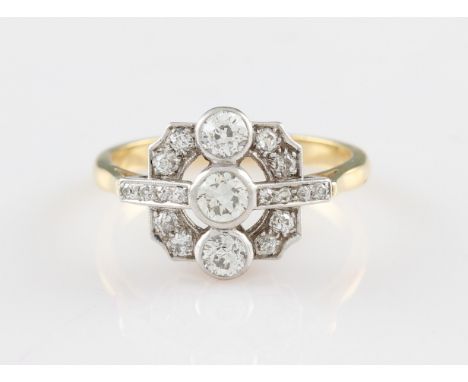 An Art Deco diamond ring, set with three graduated principal old cut diamonds, in a square open metalwork head set with furth