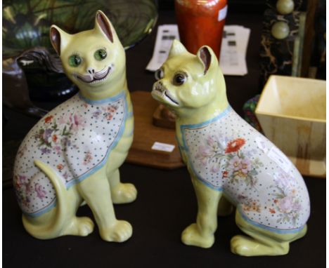 Two Galle style ceramic figures of a seated cat and dog, with yellow bodies plus floral pattern backs fitted with glass eyes.