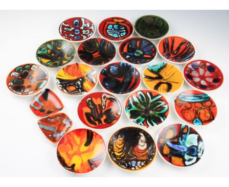 A collection of eighteen Poole pottery Delphis range shape 49 circle dishes with assorted abstract designs, some having artis