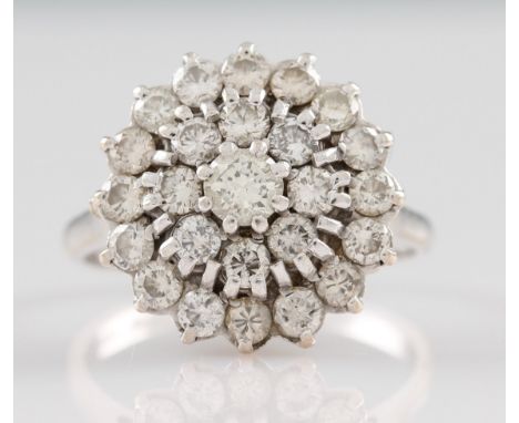 An 18ct white gold tiered diamond cluster ring, set with a central round brilliant cut diamond, approx. 0.30ct, surrounded by