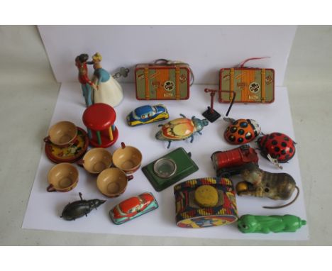 A COLLECTION OF TIN PLATE ITEMS MOSTLY WIND UP, SOME WITH KEYS, to include Cinderella and Prince Charming, two ladybirds, two
