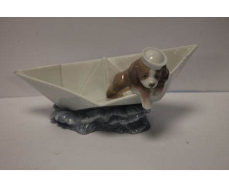 A LLADRO DOG IN A BOAT