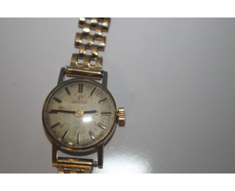 A LADIES OMEGA MANUAL WIND WRIST WATCH on an unbranded 9 ct gold strap, dedication inscription to the back, case hallmarked 9