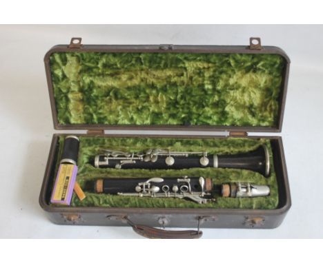 A CASED F. BUISSON B FLAT CLARINET, with cleaner and spare reeds, plate on case reads "John E. Dallas &amp; Sons Ltd. Ridgmou