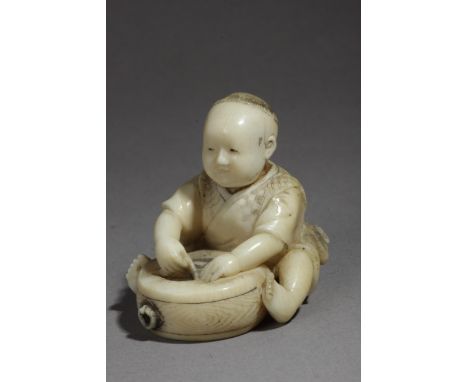 A mid 19th century Japanese netsuke. Signed on the base. In carved elephant ivory portraying a child sat on the floor and fix