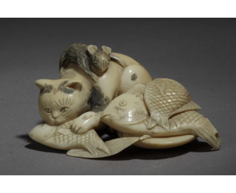 A Japanese netsuke circa 1900-1930. Signed Munetami. In carved ivory portraying a mouse lying on a cat's back, while he is ea