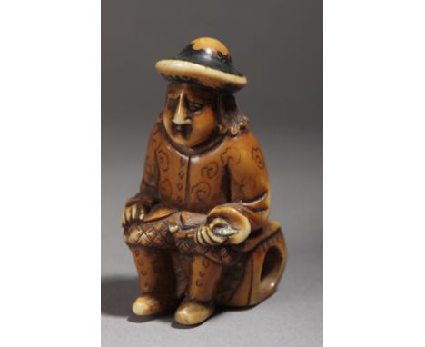 A Japanese netsuke circa 1800 from Edo period. Not signed. In carved and polychromed ivory portraying a Dutch sat on a Chines