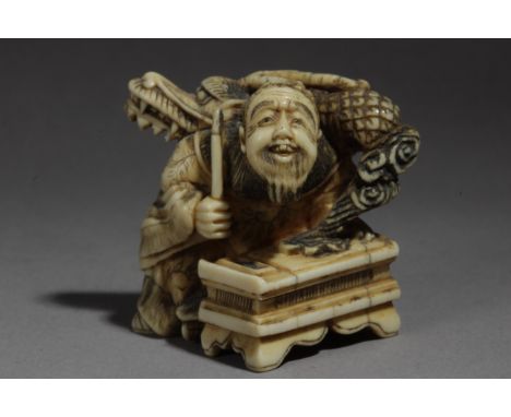 A 19th century Japanese netsuke. Not signed. In carved elephant ivory portraying Sennin 'Koshohei' sat on the floor while a d