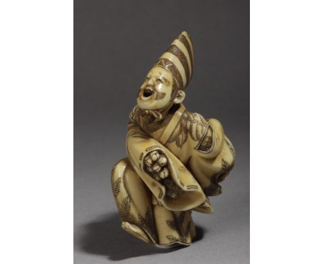 A mid 19th century Japanese netsuke, Signed Minkoku. In carved ivory portraying "Sambaso" dancing on his left leg, while hold