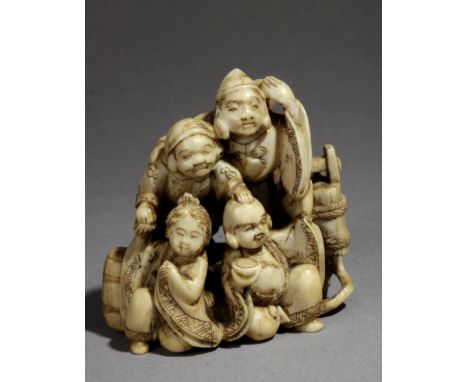 A late 19th century Japanese netsuke from Meiji period. Signed on the base. In carved ivory portraying a group of five tradit