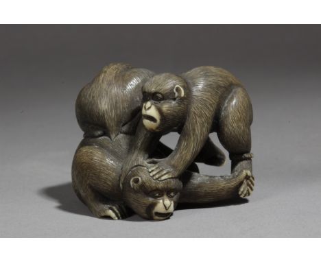 A 19th century Japanese netsuke from Meiji period. Signed Gyokumin. In carved ivory depicting a group of three monkeys tied w