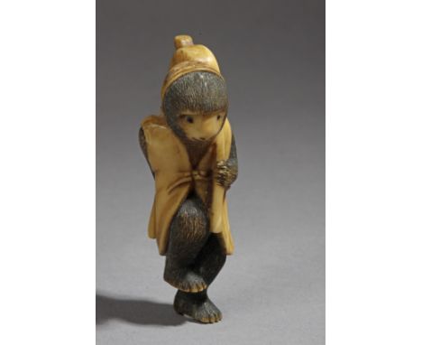 A late 19th century Japanese netsuke from Meiji period. Not signed. In carved walrus ivory portraying a monkey wearing a stre