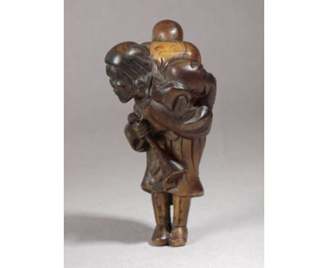 An early 19th century Japanese netsuke from Edo period. Not signed. In carved deer antler portraying a Dutch woman carrying a