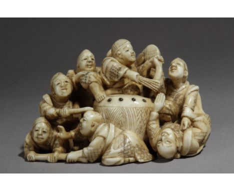 A Japanese netsuke from Meiji period circa 1860-1890. Signed Gyokuzan. In carved ivory portraying a group of nine Japanese tr