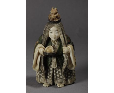 A Japanese netsuke from Meiji period circa 1900. Signed Yasuhide on a red kanji on the back. In carved, polychromed and inlai