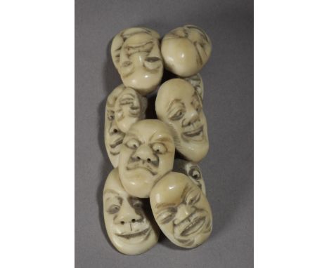 A Japanese netsuke from Meiji period circa 1900. Signed on the base. In carved elephant ivory portraying a group of eleven ma