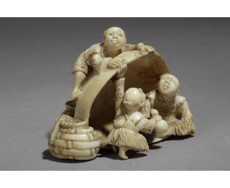 A late 19th century Japanese netsuke from Meiji period. Signed on the base. In carved elephant ivory portraying a group of ch