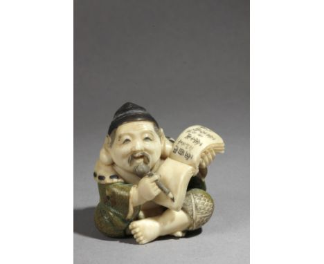 A Japanese netsuke from Meiji period circa 1900. Signed Yasuaki. In carved, polychromed and inlaid ivory portraying a leg-cro