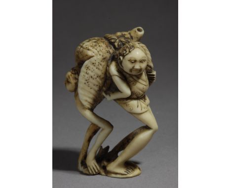 A late 19th century Japanese netsuke from Meiji period. Signed Tenkazu. In carved ivory portraying a standing "Ashinaga" carr