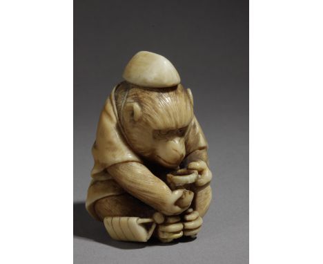 A 19th century Japanese netsuke from Edo period. Signed Masatsugu. In carved ivory depicting a monkey sat on the floor while 