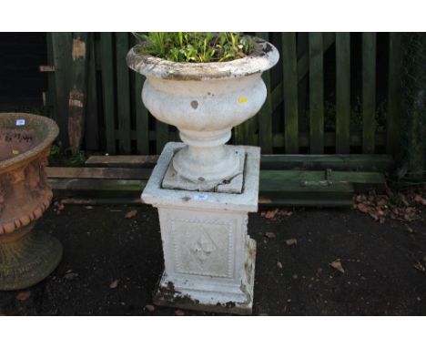 A concrete planter raised on plinths