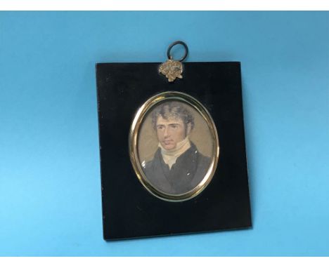 A miniature portrait of a Gentleman, with ebonised mount and gold plated frame