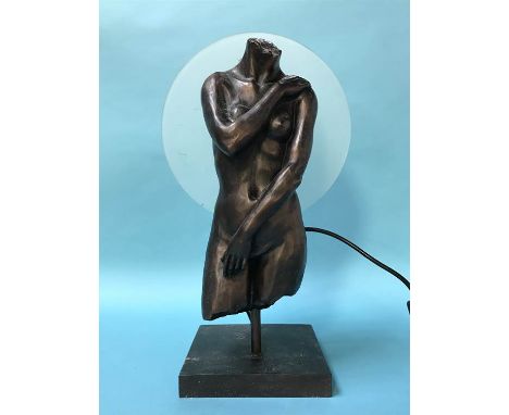 A figural table lamp of a torso