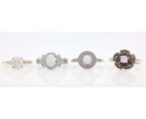 Four silver opal and cubic zirconia rings stamped SIL and 925   Condition Report   Click here for further images, condition, 