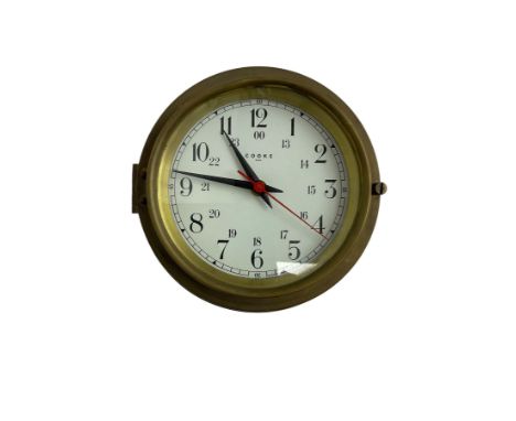 Contemporary quartz timepiece in the style of a ship's bulkhead clock, with a 5� dial and 9� spun brass case, with a white 24