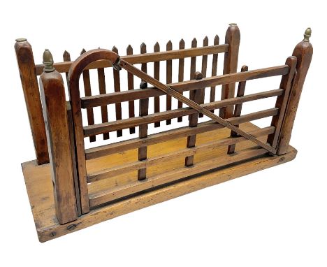 Early 20th century novelty letter rack modelled as a gate and picket fence, with brass post finials, on pine base, L43cm