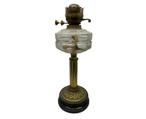 Early 20th century brass oil lamp with ornate foliate base and clear glass reservoir, H46cm
