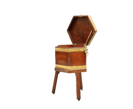 A GEORGE III MAHOGANY CELLARETTE, the hexagonal cellarette with brass binding and ring handles, the hinged cover opening to r