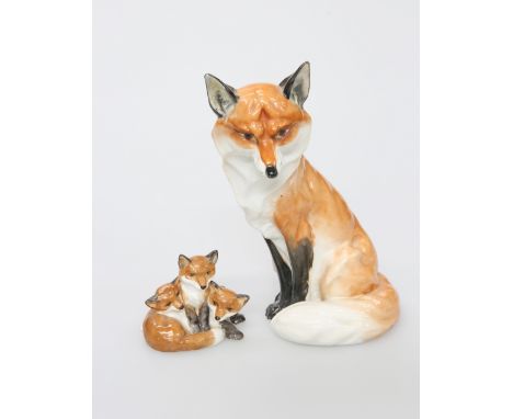 A ROYAL WORCESTER MODEL OF A SEATED FOX, no. 2993, 18.5cm; together with A ROYAL WORCESTER MODEL OF FOX CUBS, no. 313. (2)The